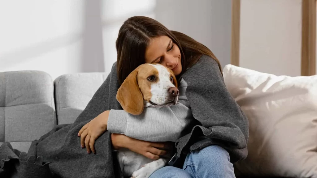 Woman hugging dog to support someone with anxiety in helpful tips article