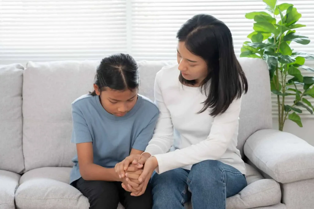 Mom talking to her daughter, illustrating ways to support and improve a child’s mental health