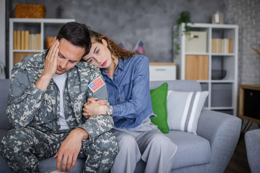 Person hugging her husband, illustrating support and ways to help someone struggling with PTSD.