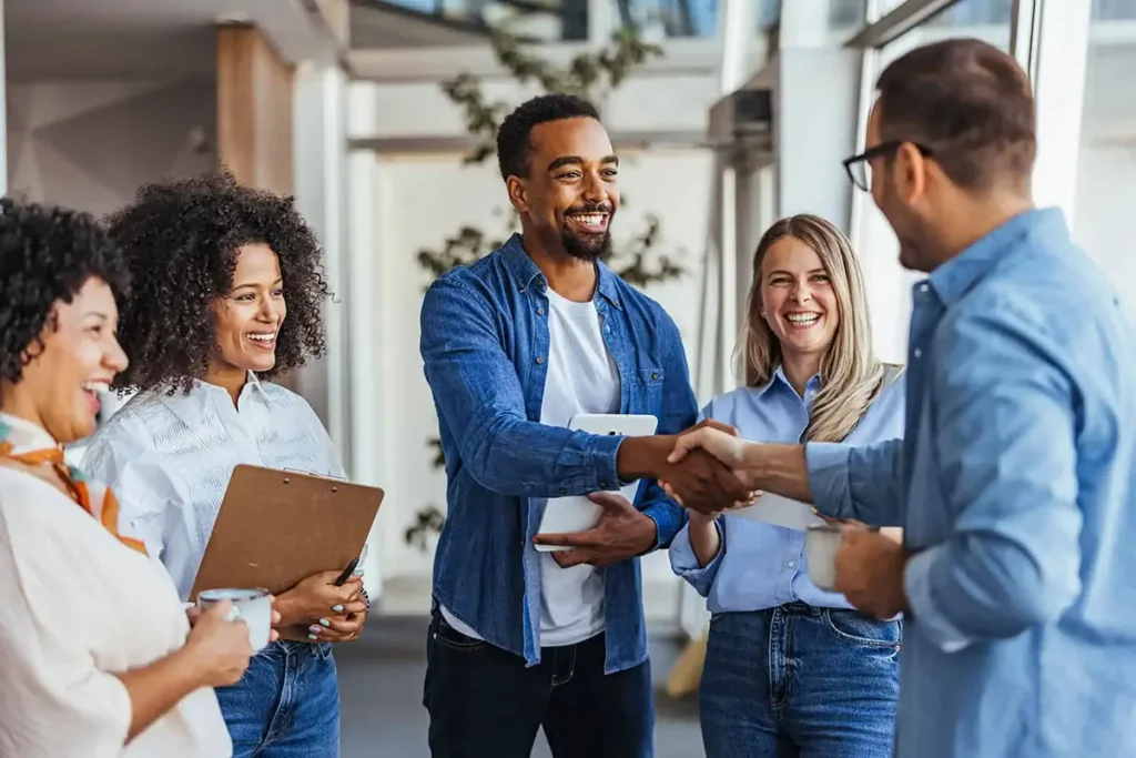 People shaking hands image illustrating tips to become a valuable and effective employee