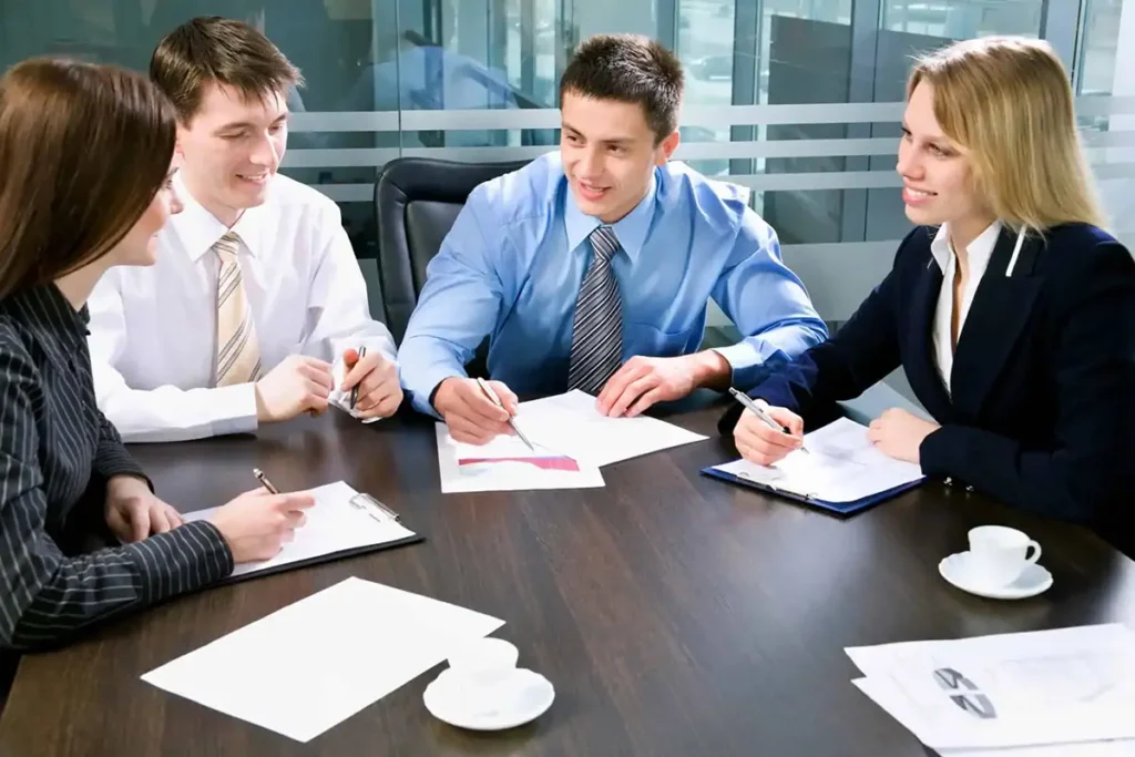 People talking in a business setting, illustrating how to deal with workplace competition