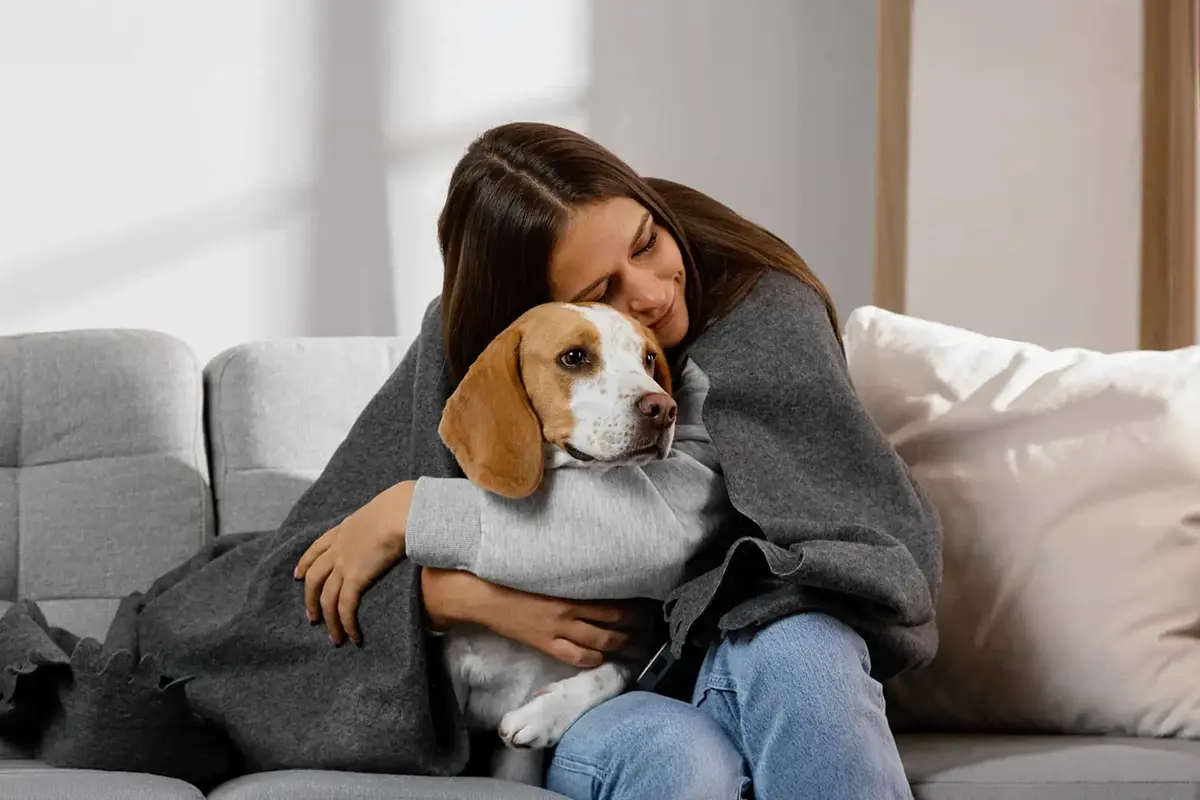 Woman hugging dog to support someone with anxiety in helpful tips article