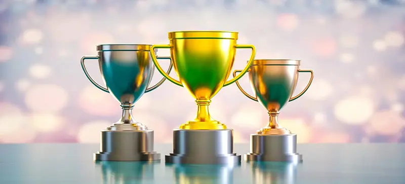 Three trophies image representing achievements and awards on Stan’s award page.