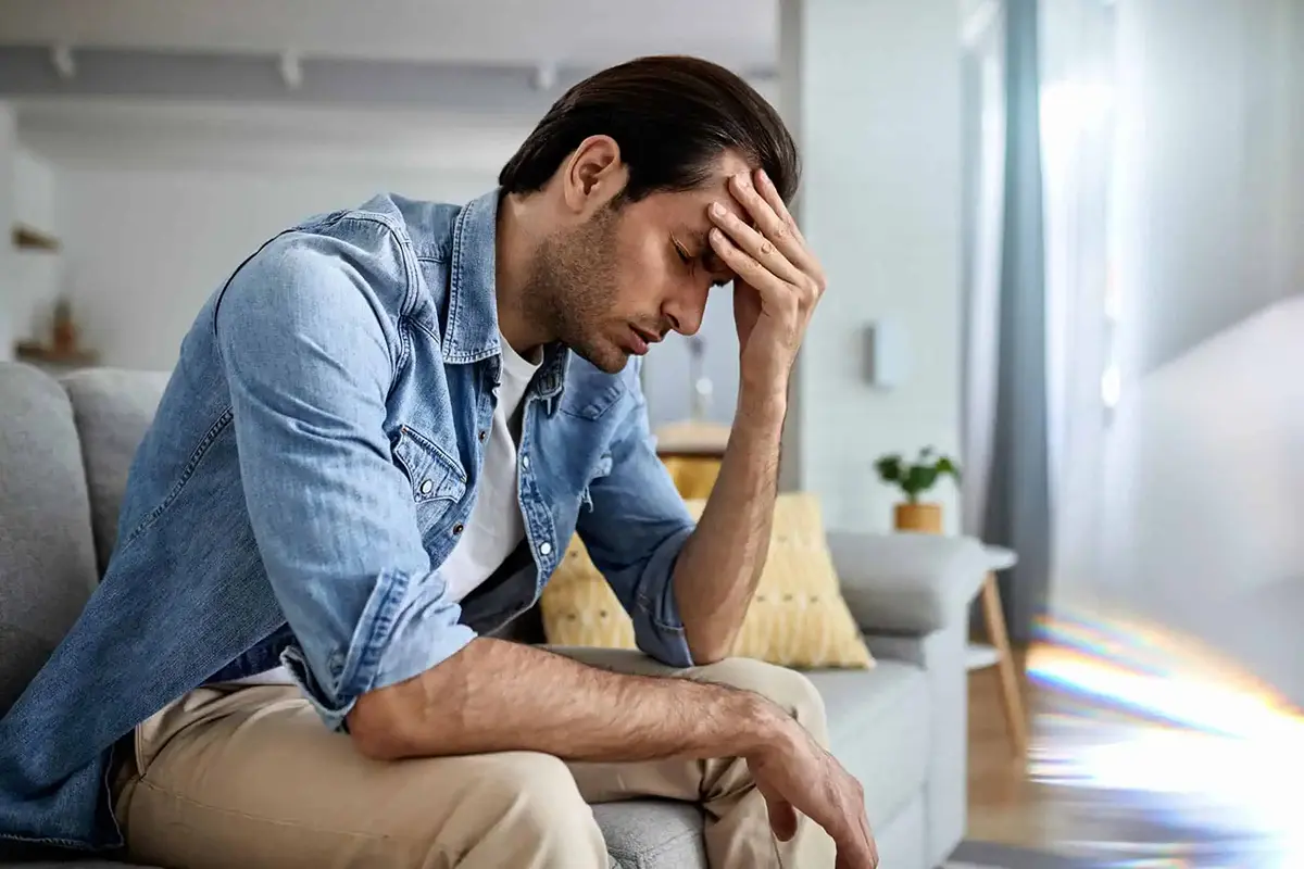Image of a sad person sitting on a chair for tips on how to overcome depression